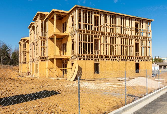 workers protected by temporary barrier fence during building maintenance in Chubbuck ID